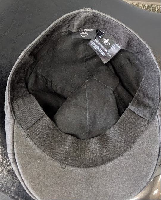 Gray cap with a brand tag on a white background