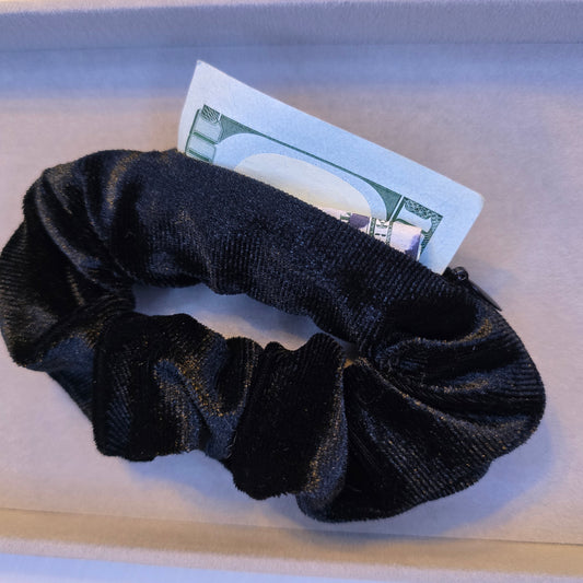 Black scrunchie with a zipper to hide money or belongings 