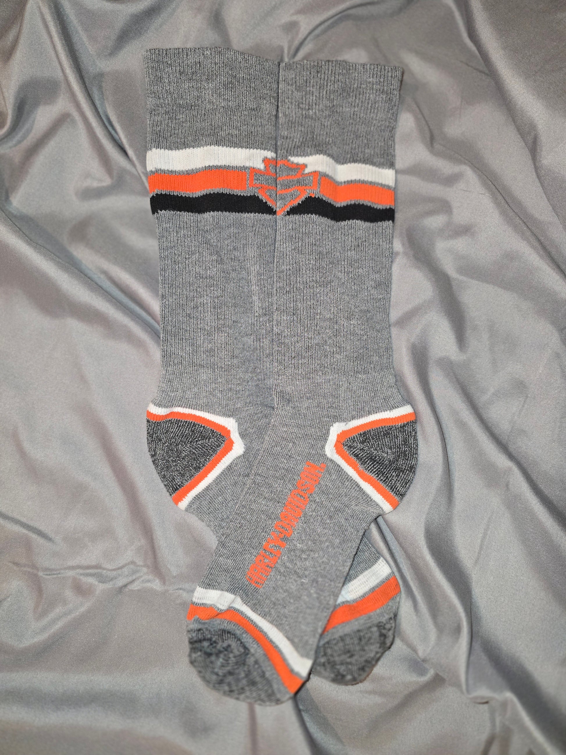 Feel the ultimate comfort and support with our Gray Harley Davidson Socks. Made with high-quality materials, these socks are perfect for any avid motorcycle enthusiast. Experience maximum comfort and durability while showing off your love for the iconic brand. Upgrade your sock game and ride in style with these Gray Harley Davidson Socks!