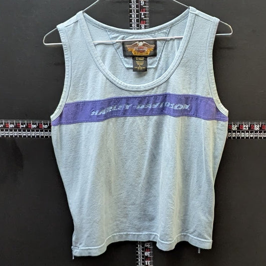 Light blue tank top with purple stripe on a hanger against a dark background