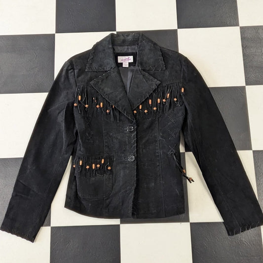 Leather suede jacket with orange buttons and decorative elements on a checkered background