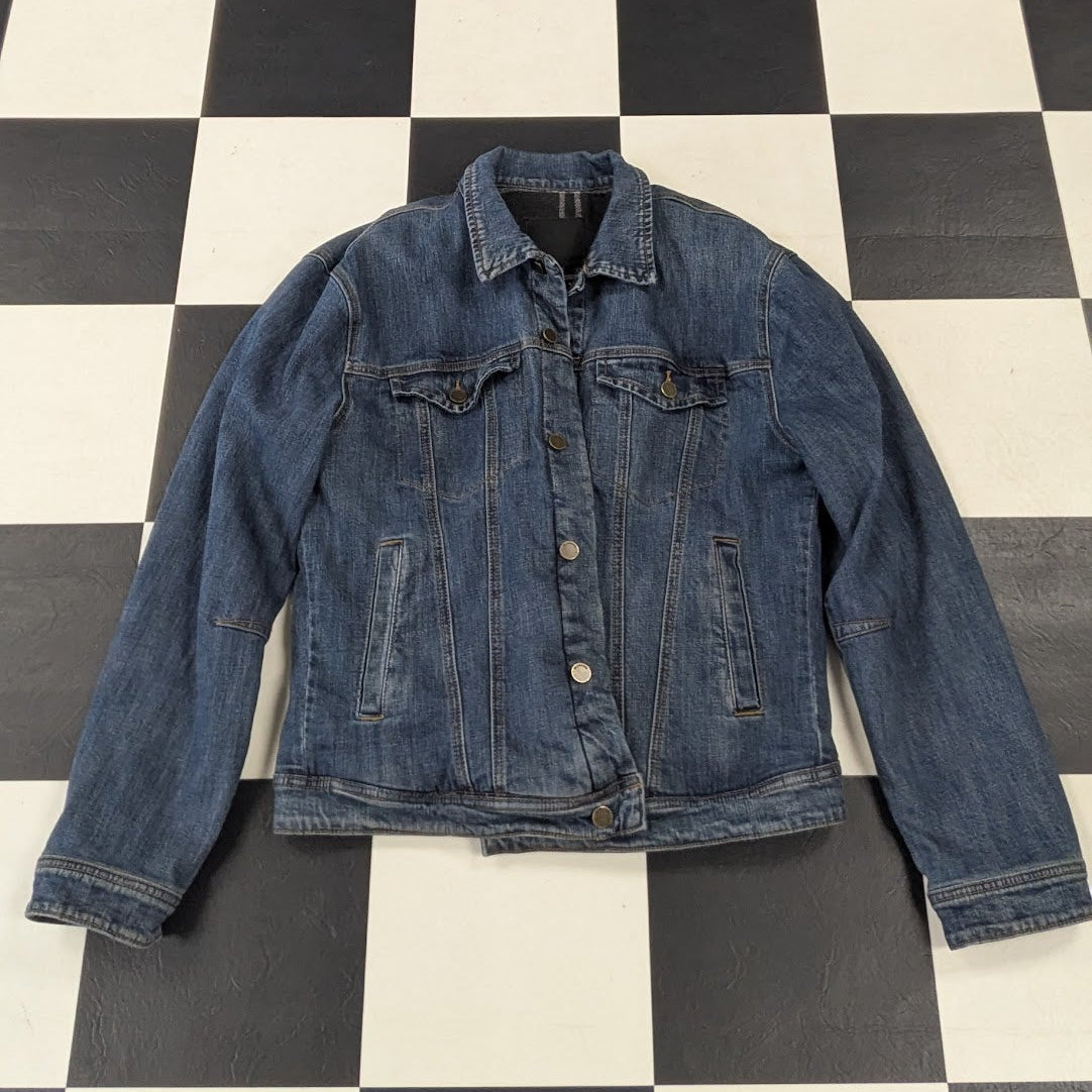 Blue denim jacket on a black and white checkered floor
