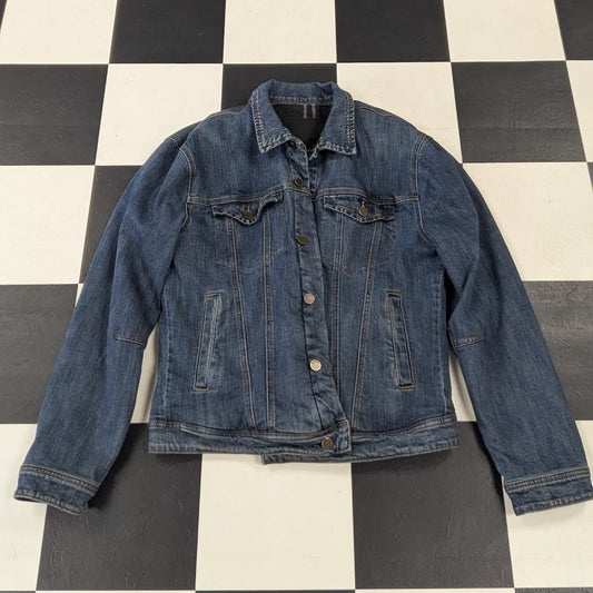 Blue denim jacket on a black and white checkered floor