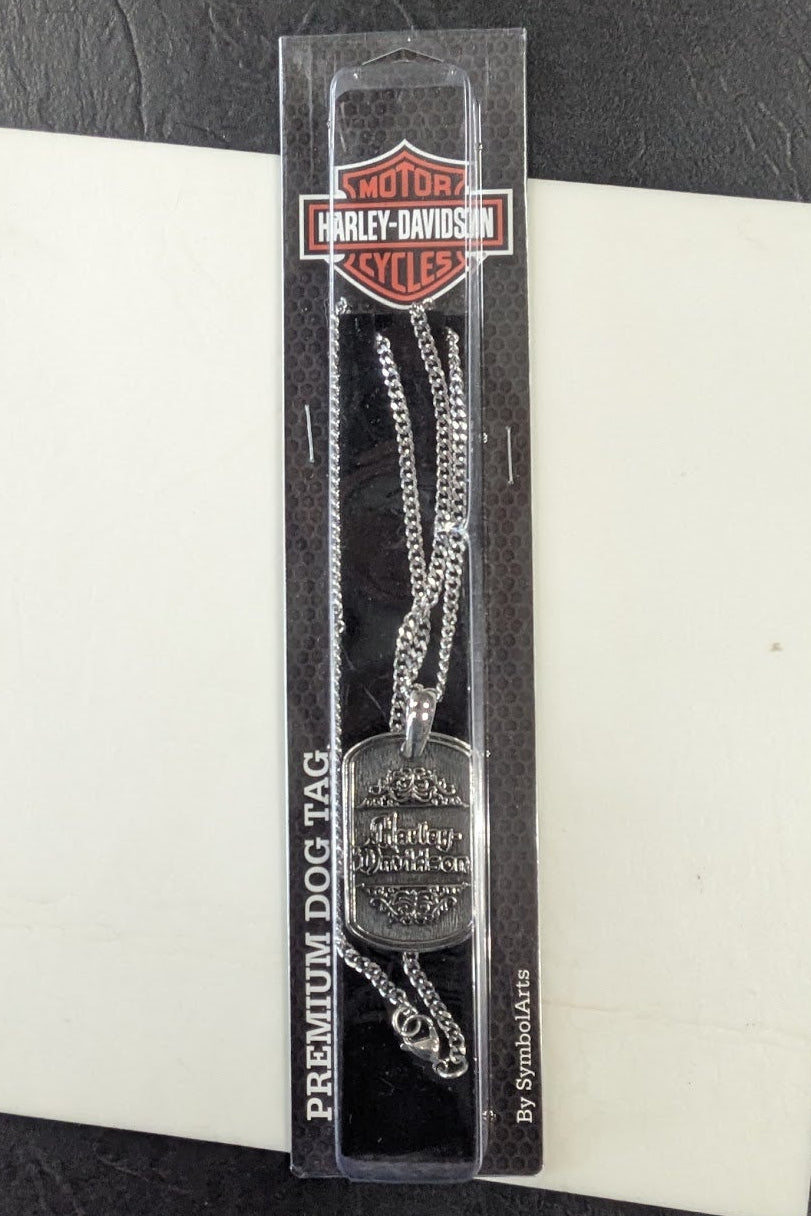 Harley-Davidson dog tag in clear packaging on a checkered background