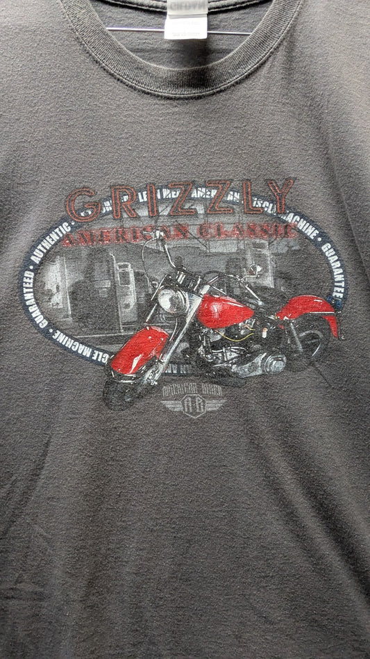 A dark gray heather graphic t-shirt featuring a red and black motorcycle print with the text 'GRIZZLY AMERICAN CLASSIC' and a Harley-Davidson logo.